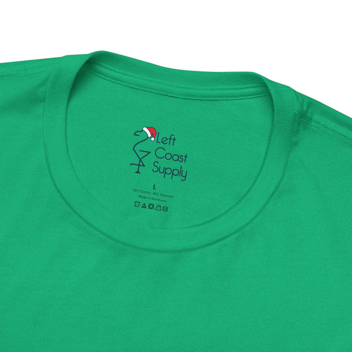 Green t-shirt with a navy outline of a flamingo wearing a Santa hat. Left Coast Supply