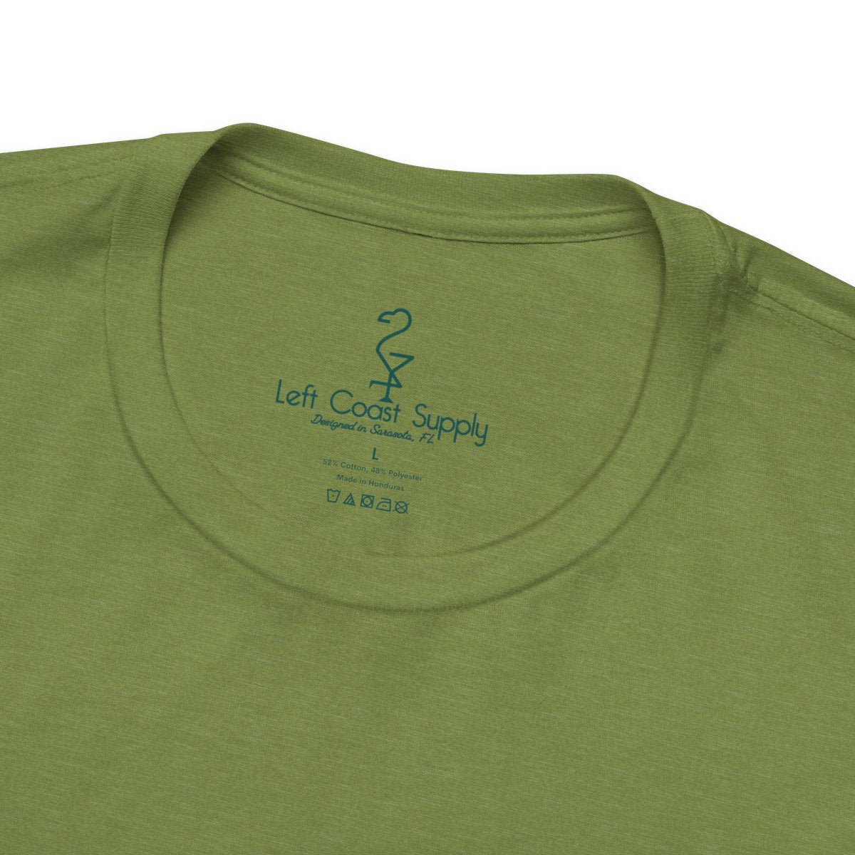 Green t-shirt with a leaf-patterned creature graphic on the back. Left Coast Supply