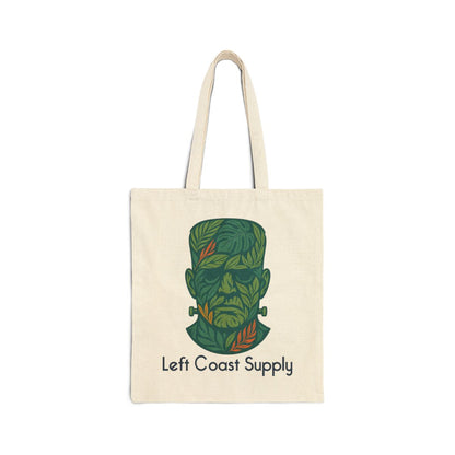 An off-white canvas tote bag with two shoulder straps, featuring a stylized green Frankenstein's monster head graphic made of leaves, with the text 'Left Coast Supply' printed below, on a solid white background.