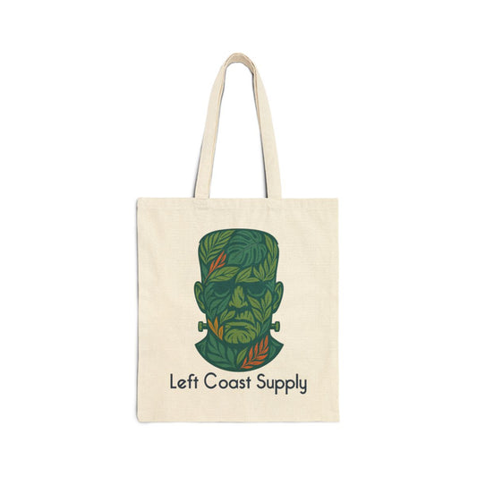 An off-white canvas tote bag with two shoulder straps, featuring a stylized green Frankenstein's monster head graphic made of leaves, with the text 'Left Coast Supply' printed below, on a solid white background.