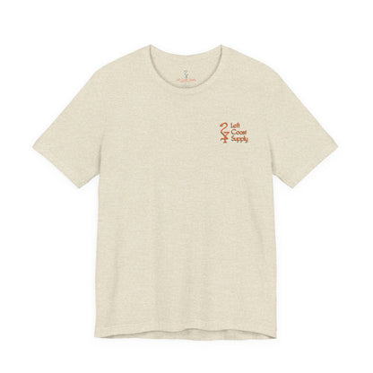 Beige t-shirt with a tropical Santa Claus graphic and 'Christmas Spirits'. Left Coast Supply