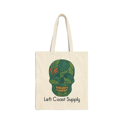 An off-white canvas tote bag with two shoulder straps, featuring a green leaf-patterned skull graphic and the text 'Left Coast Supply' printed below it, set against a plain white background.