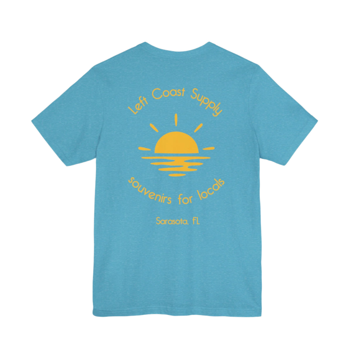 Blue t-shirt with yellow graphic of sunset with souvenirs for locals written. Left Coast Supply