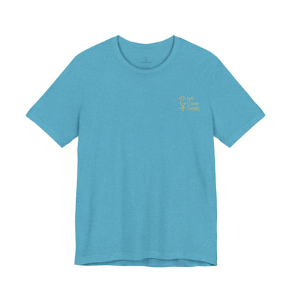 Blue t-shirt with yellow graphic of sunset with souvenirs for locals written. Left Coast Supply