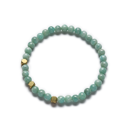 A stretch bracelet made with green amazonite beads and raw brass accents. Left Coast Supply