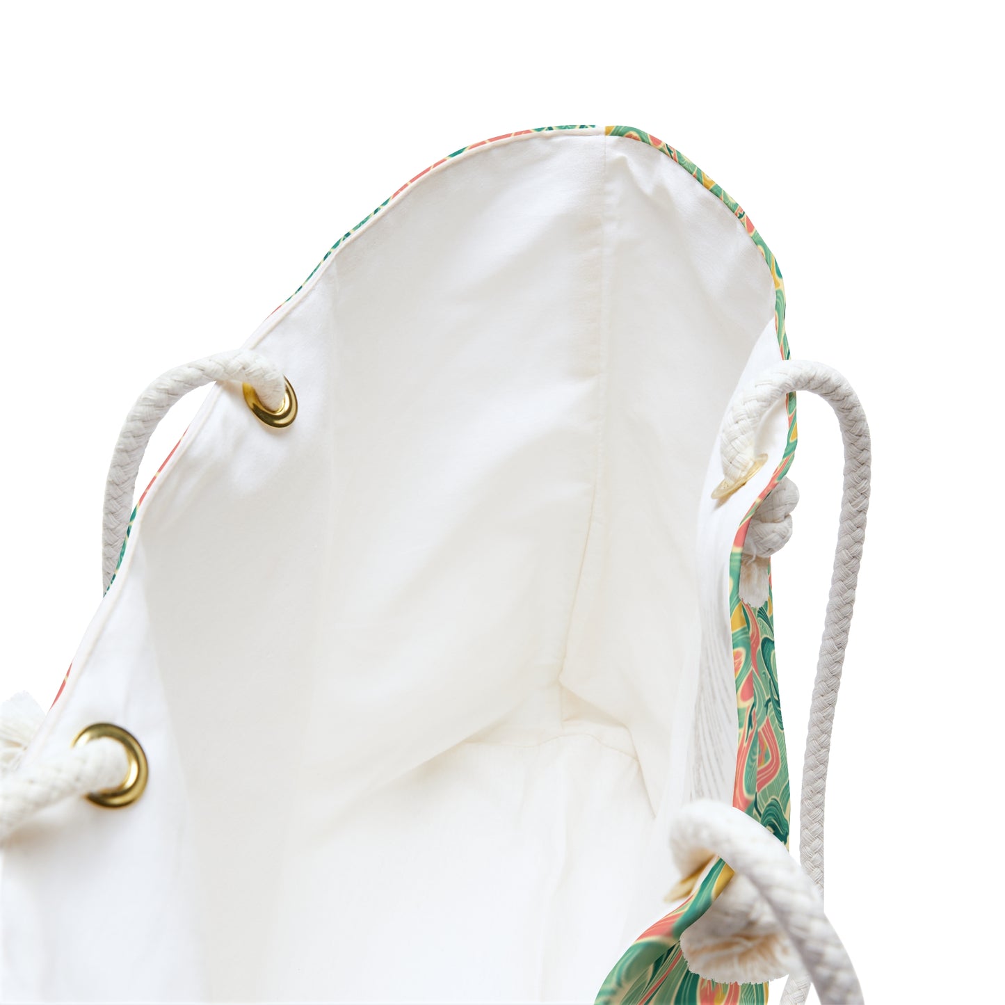 Beach tote with a watercolor pattern featuring mermaids and sunset hues, with white nautical rope handles. Left Coast Supply