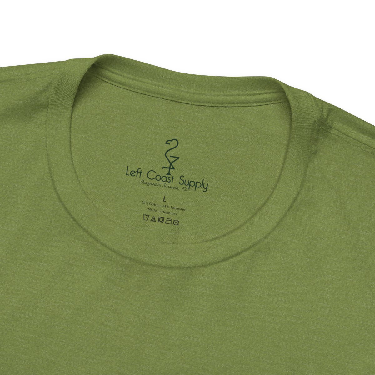 Purple t-shirt with a graphic of a monster and leaves on the back. Left Coast Supply