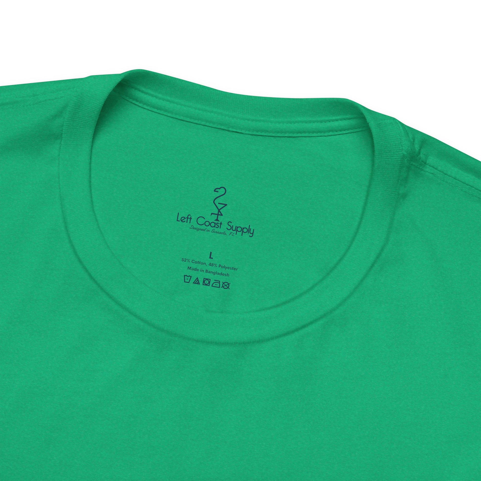 A green crew neck t-shirt with a graphic print of a white ibis bird, a pot of gold, and the text 'Kiss Me I'm Ibis'. Left Coast Supply