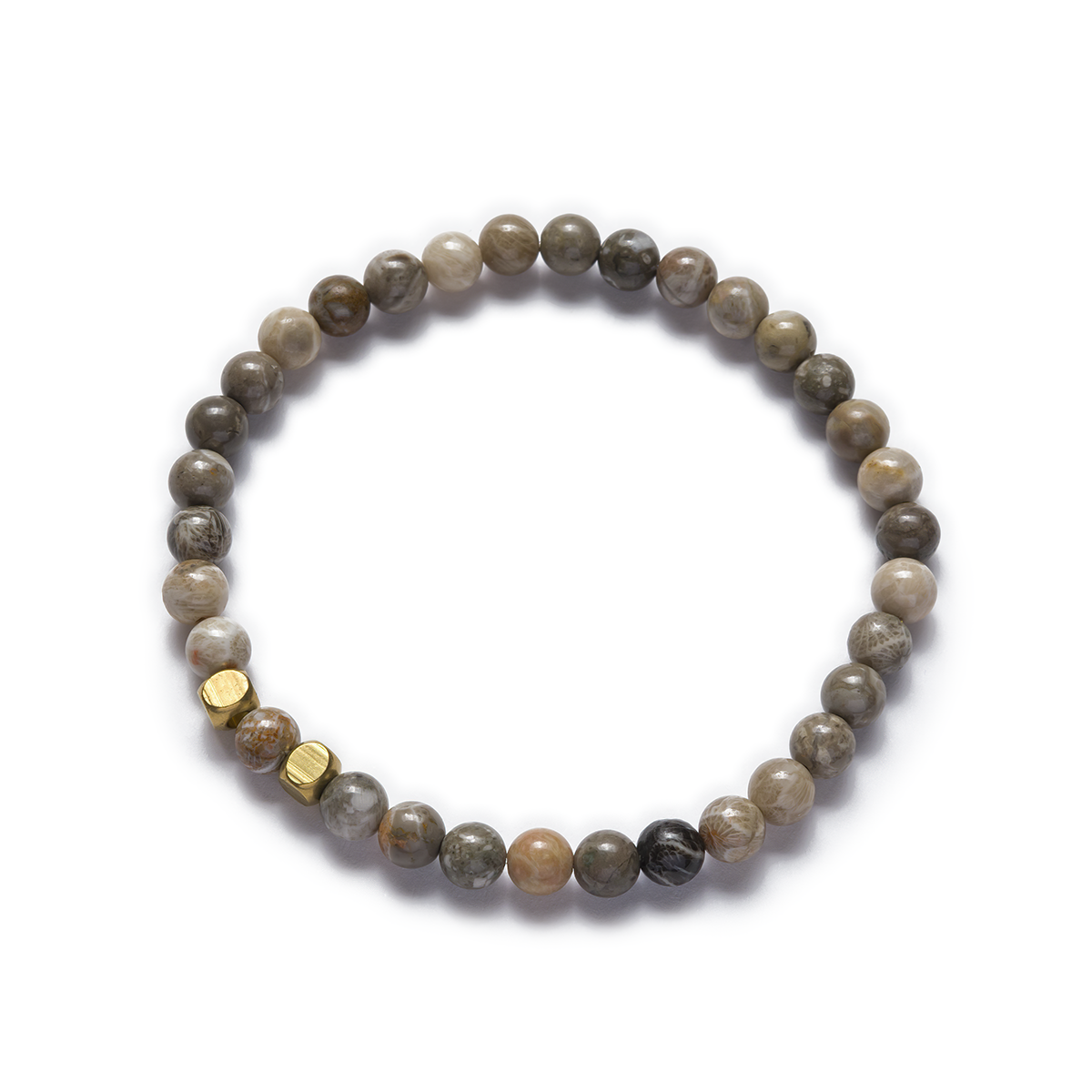A stretch bracelet made of natural fossil coral beads and raw brass details Left Coast Supply