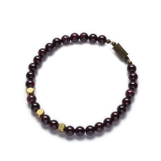A garnet bracelet with magnetic clasp, featuring round red beads and raw brass accents. Left Coast Supply