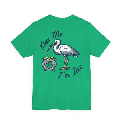 A green crew neck t-shirt with a graphic print of a white ibis bird, a pot of gold, and the text 'Kiss Me I'm Ibis'. Left Coast Supply