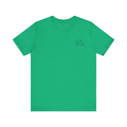 A green crew neck t-shirt with a graphic print of a white ibis bird, a pot of gold, and the text 'Kiss Me I'm Ibis'. Left Coast Supply