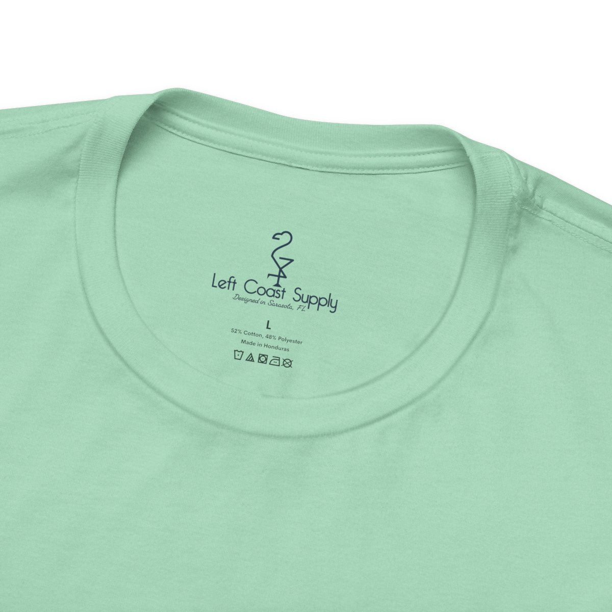 Light green t-shirt with a pink flamingo graphic and 'Left Coast Supply'