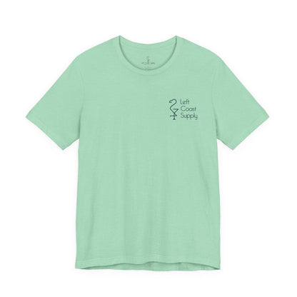 Light green t-shirt with a pink flamingo graphic and 'Left Coast Supply'