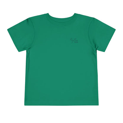 Green toddler T-shirt with the text 'Kiss Me I'm Ibis' and an illustration of an ibis bird and a pot of gold. Left Coast Supply
